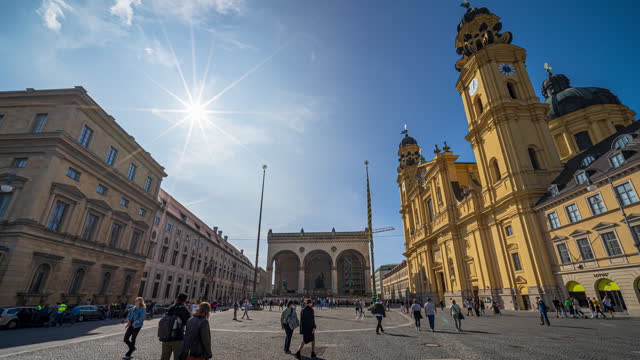 4K Footage Time Lapse of Crowded of People and tourist walking around odeonsplatz, theatinerkirche or theatine church and munich residenz, hofgarten in Munich, Germany, Europe
