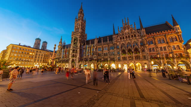 4K Footage Day to Night Time lapse of Crowd of People tourist walking and sightseeing attraction at Marienplatz a central square in the city centre of Munich and New Town Hall, Munich, Bavaria,Germany