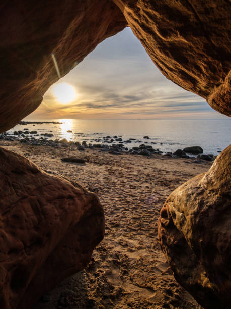 Twilight's Silhouette: Sunset View from Veczemju Klintis Cave