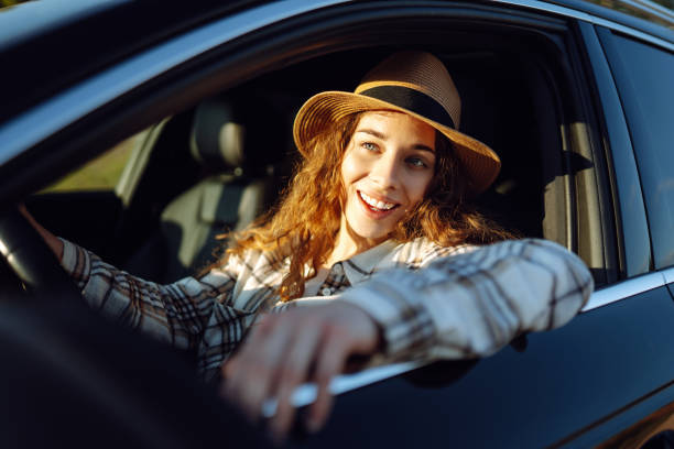 istock Beautiful young woman driving her car. 2045887564