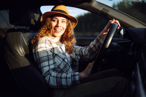 istock Beautiful young woman driving her car. 2045888882