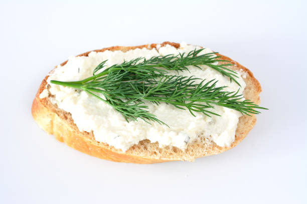 Homemade spreadable cheese made of organic kefir drink, wholemeal bread and fresh spring onions - healthy nutrition concept