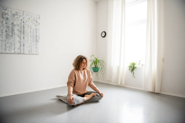 istock Woman doing yoga at home 2045944313