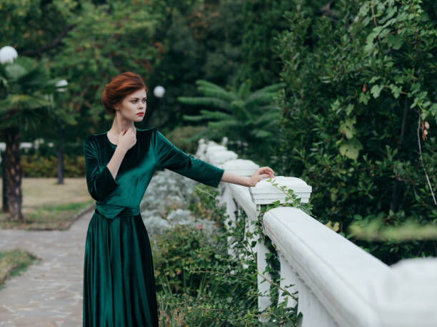 istock woman outdoors walk green dress romance 2045967694