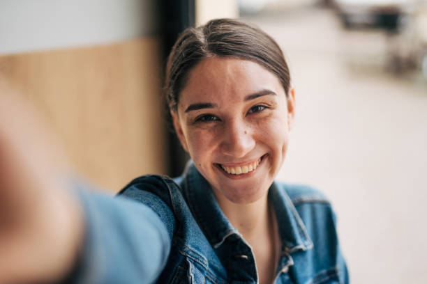 istock Young woman taking a selfie with her smartphone 2045981587