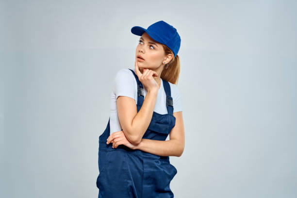 istock Woman in working uniform blue cap service lifestyle service 2045994260
