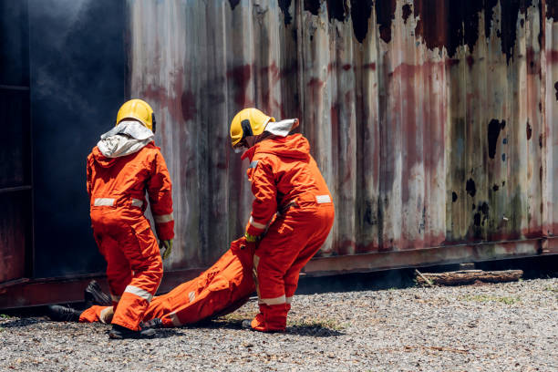 First aid support accident at work. Firefighter to save girl in fire and smoke. Rescue Team or Firefighters save lives people from fire. Firefighter or Emergency team rescue saving life people