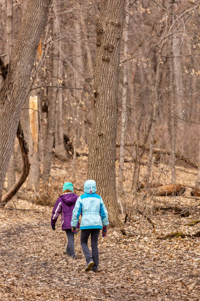 istock Two Girls Walking in Woods in Springtime 2046008609