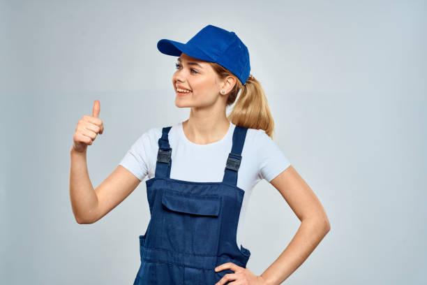 istock Woman in working uniform blue cap service lifestyle service 2046031705