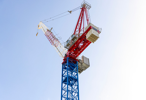 Low angle view of tower crane, sky background with copy space, full frame horizontal composition