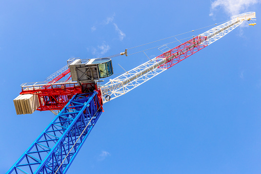 Low angle view of tower crane, sky background with copy space, full frame horizontal composition