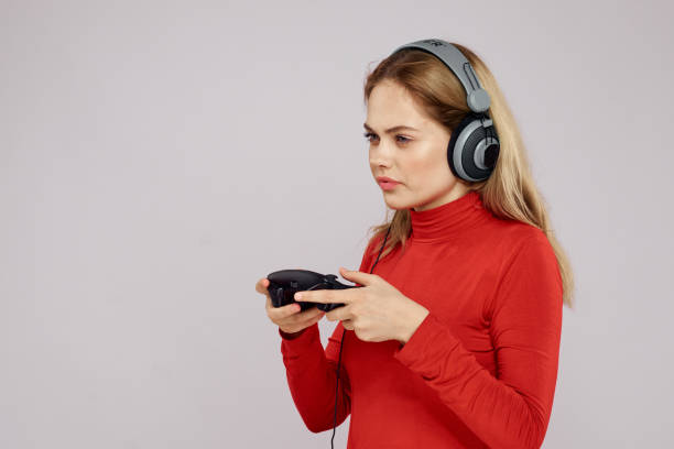istock Woman in red sweater joystick playing fun recreation 2046070361