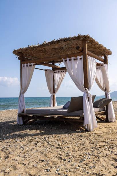 istock Crete on the beach with beach bed, typical sun roof and sea 2046071449
