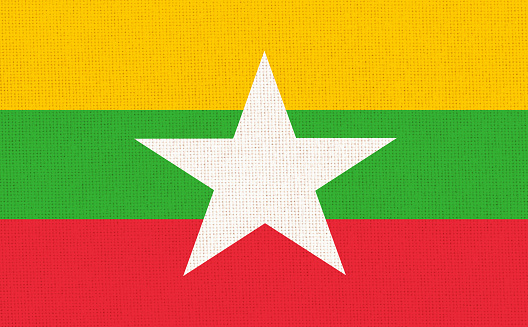 Flag of Myanmar on fabric surface. Burmar national flag on textured background. Burma state flag. Fabric Texture. Republic of the Union of Myanmar. Asian country