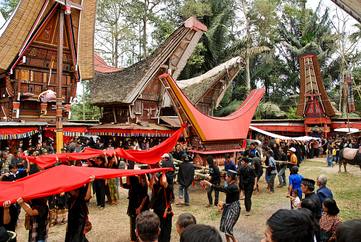 Tana Toraja, Sulawesi, Indonesia - Oct 20, 2009: during a Toraja funeral ceremony, the coffin and image of the deceased are carried in a long and elaborate procession through the streets of the village, near Rantapao, Sulawesi.