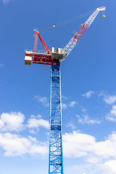 Low angle view of tower crane, sky background with copy space, full frame hvertical composition