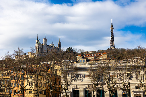 Metallic tower and Basilica of Fourvière from the banks of the Saône River in Lyon