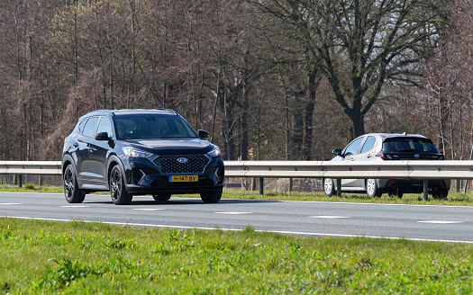 Netherlands, Overijssel, Twente, Wierden, March 19th 2023, side/front view close-up of a Dutch black 2019 Hyundai 3rd generation Tucson SUV driving on the N36 at Wierden, the Tucson has been made by South Korean manufacturer Hyundai Motor Company since 2004, the N36 is a 36 kilometer long highway from Wierden to Ommen