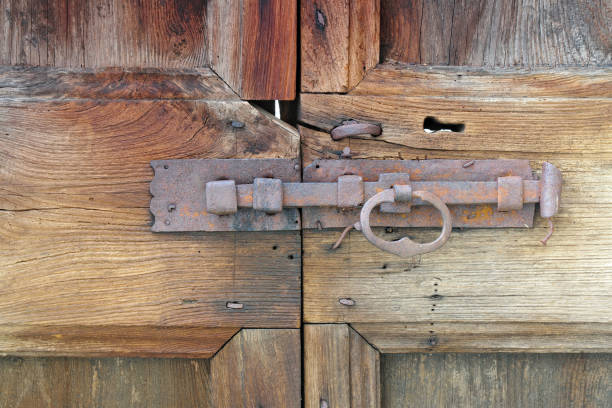 an old antique rusty latch on a wooden door