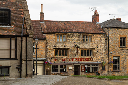 Sherborne, England, July 20, 2017; Front facade of the Grade II listed 16th century pub - The Plume Of Feathers, in the center of Sherborne ; Dorset, England.