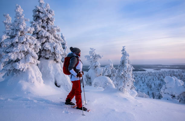 istock Woman snowshoeing on snowy mountain 2046164202