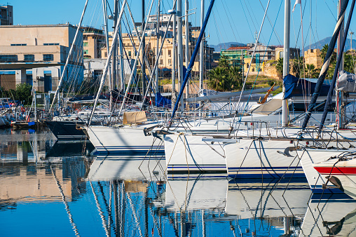 Explore the tranquil allure of Palermo's marina, where sailboats gracefully adorn the serene waters, epitomizing the gentle maritime lifestyle of this captivating Italian coastal city. The serene marina in Palermo, Italy paints a tranquil picture of maritime bliss in Sicily island