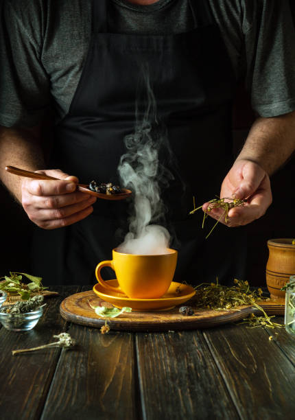 istock A man prepares tea from the medicinal plants rosehip and chamomile on the kitchen table. Traditional medicine concept at home 2046179597