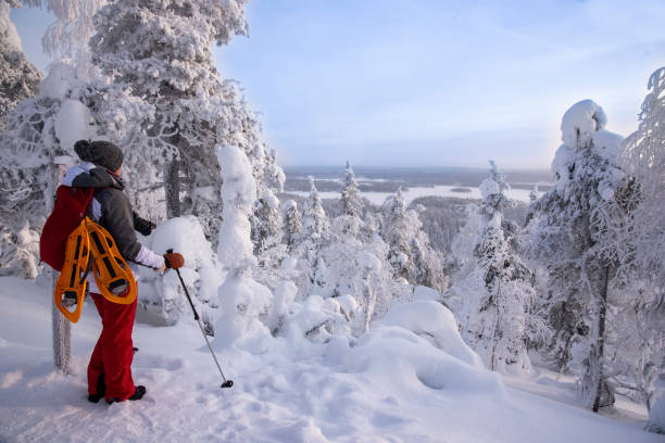 istock Woman snowshoeing on snowy mountain 2046181250