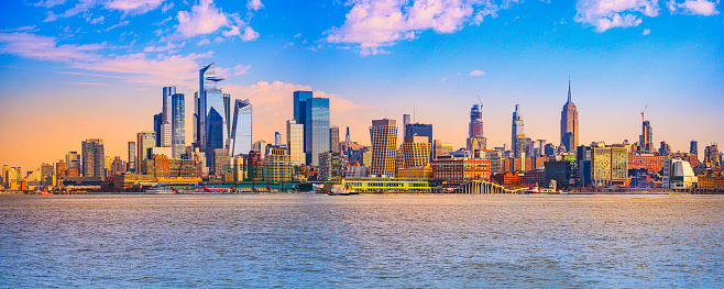 Sunrise over New York City Lower Manhattan Skyline and skyscrapers and the Hudson River, the view from Pier C Panoramic Viewpoint in Hoboken, New Jersey, USA