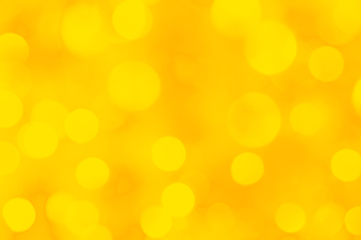 Defocused background in yellow tones. Beautiful bokeh lights.