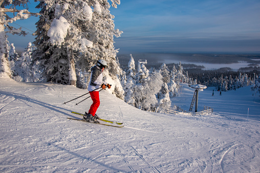 Woman downhill skiing  in Lapland Finland