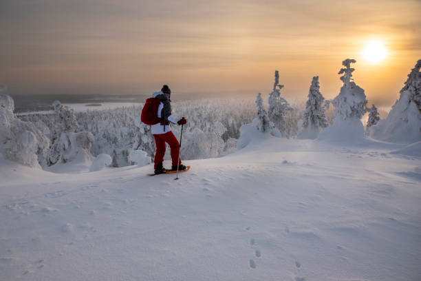 istock Woman snowshoeing on snowy mountain 2046200100