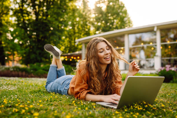 istock Pretty woman with laptop on the green grass. 2046201739