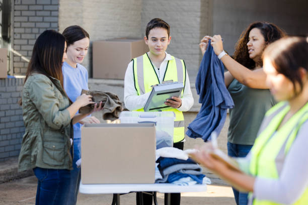 istock Diverse group of volunteers help fold and organize clothing 2046206027