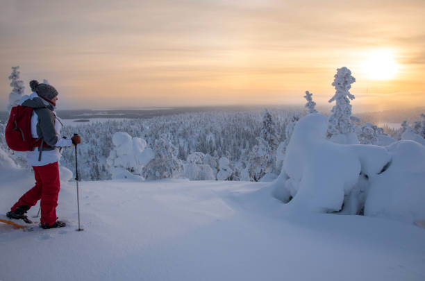 istock Woman snowshoeing on snowy mountain 2046227870