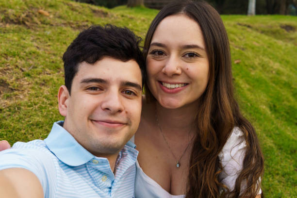 istock two friends taking a picture in the park 2046241264