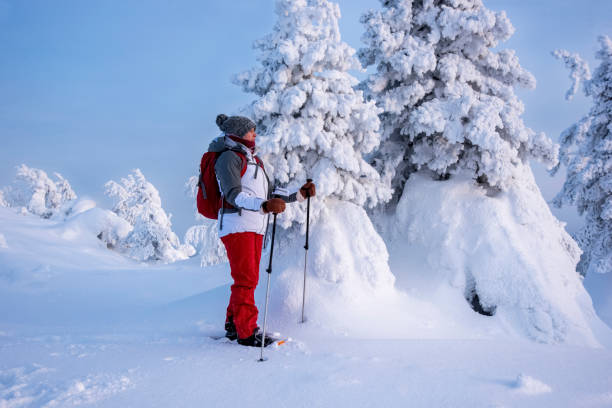 istock Woman snowshoeing on snowy mountain 2046243900