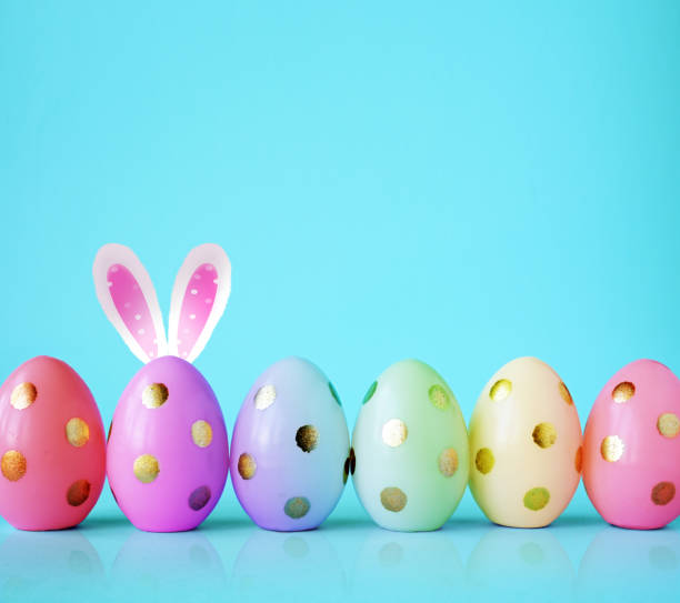 istock Collection of stylish colors eggs with golden circles for Easter celebration on blue background. 2046247268