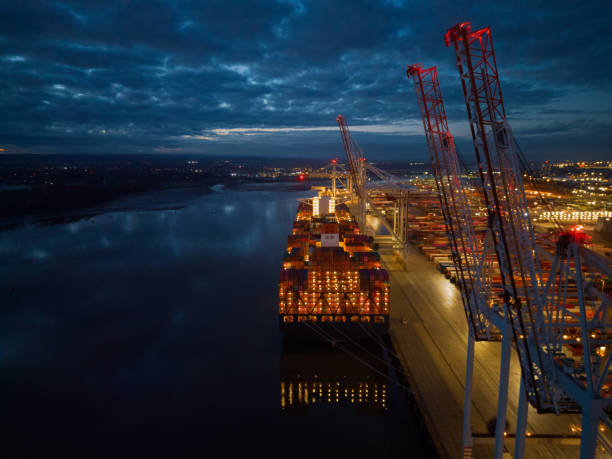 istock Container ship lights at dusk with crane at Southampton Docks UK aerial 2046255090