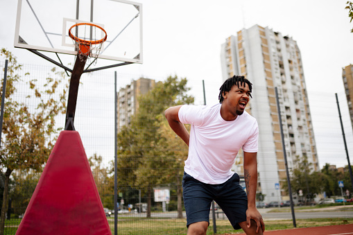 Picture of young african basketball player practicing outdoor. Fit afro man in motion and movement. athletic and sport lifestyle