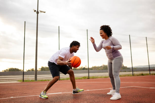 istock Young african-american couple playing basketball 2046261994