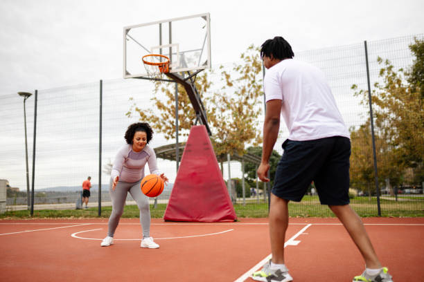 istock Young african-american couple playing basketball 2046264657