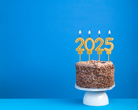 Happy new year 2025 on cake on blue background