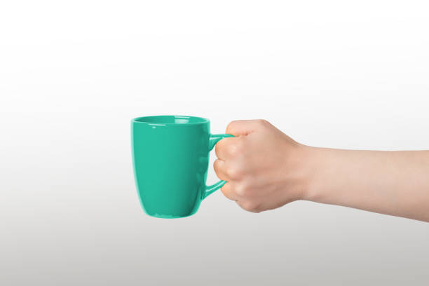 istock Green cup held for promoting logo or illustrating coffee and tea sipping 2046277483