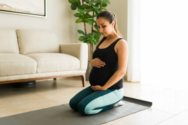 istock Relaxed expecting mother smiling touching her pregnant belly after exercising 2046284861