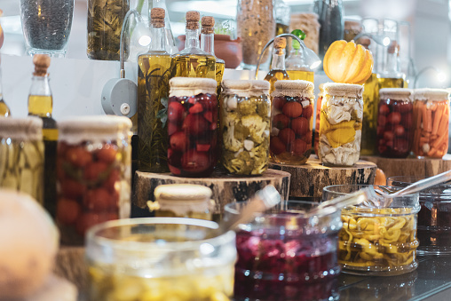 Various Canned Pickles in glass jars on the counter
