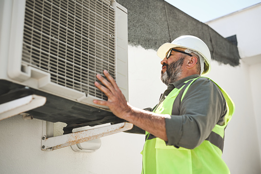 engineer repairs air conditioner