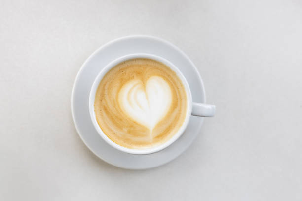 istock Coffee on a White Background. Coffee in a white cup with latte art. Flat lay, copy space. Cafe culture. 2046355249