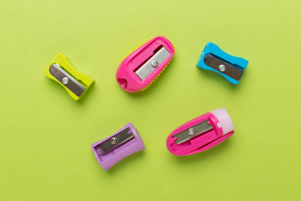 Pencil sharpener on bright colored background. Pencil and pencil shavings. Stationery. School supplies. School products. Flat lay. Place for text. copy space.