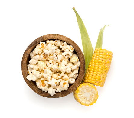 Popcorn in bowl with cob isolated on white, top view